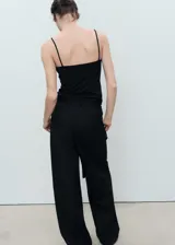 Top negro ajustado al cuerpo con tirantes finos y escote cuadrado.