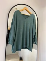 Sweater verde oliva de corte recto, con cuello en pico y punto elástico en los puños.