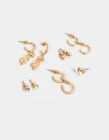 Set de seis pares de aros dorados: tres pares de aros tipo botón (con perla, con strass y liso) y tres pares de aros tipo argolla (lisos, con strass y con dije de zapatillas de ballet).