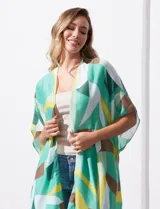 Kimono tejido con estampado geométrico en tonos verde, amarillo y marrón. Tiene mangas amplias estilo japonés y terminación de ruedo con borlas.