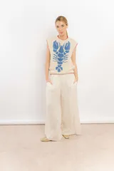 Chaleco tejido color crema con diseño de langosta azul y detalles en rojo en cuello y ruedo.