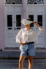 Cinturón de cuero negro liso con hebilla metálica redonda de color plateado.