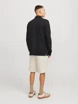 Short chino color beige de lino y algodón, con corte relajado, tiro semi caído, cintura con cordón ajustable, bolsillos delanteros y traseros.