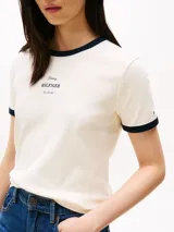 Remera de algodón color crema con cuello redondo y mangas cortas con ribetes azul marino. Logo de Tommy Hilfiger bordado en el pecho. Corte regular.