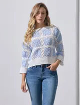 Buzo calado de acrílico, marca Sioni, color celeste y blanco, con cuello a la base y mangas tres cuartos.
