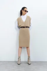 Vestido tejido color beige con escote en V y diseño acanalado.