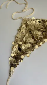 Top dorado con lentejuelas, de corte crop y escote halter.