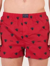 Bóxer de algodón blanco con estampado de flores pequeñas color celeste, con cintura elástica y logo de la marca en el centro.