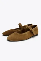 Zapato plano tipo bailarina en serraje color marrón. Escote redondo y cierre mediante hebilla en el empeine.