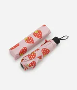 Sombrilla plegable con estampa de frutillas, confeccionada en poliéster e incluye saquito para guardar.