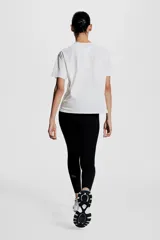 Remera deportiva blanca de corte holgado, cuello redondo y mangas raglán cortas. Confeccionada en tejido funcional DryMove™ con detalle reflectante en la espalda.