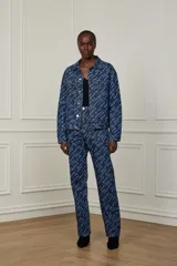 Pantalón de jean azul con estampado de letras en color blanco.