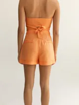 Top color ocre con escote halter cruzado y espalda descubierta.