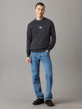Sweater gris oscuro de punto de algodón con cuello redondo, puños y bajo acanalados. Presenta el logo de Calvin Klein bordado en el pecho.