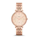 Reloj Fossil para mujer, con caja y pulsera de acero inoxidable color oro rosa, bisel con cristales, esfera color crema con números romanos y agujas doradas.