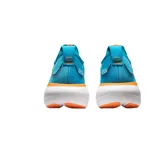 Championes de running Asics Gel-Nimbus 25, color blanco con detalles en negro, rojo y celeste.