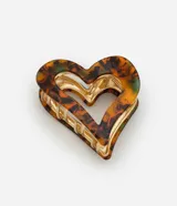 Pinza para el pelo con forma de corazón, diseño marmolado en tonos marrón, naranja y verde, y detalles metálicos dorados.
