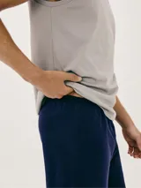 Conjunto de pijama para hombre, compuesto por una musculosa beige y un short verde oliva.