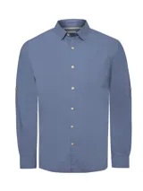 Camisa de manga larga color celeste, confeccionada en popelina de algodón orgánico. Tiene cuello clásico, cierre frontal con botones de madera, bolsillo en el pecho con logo bordado y mangas ajustables con botón.