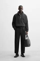 Sudadera gris oscuro de tejido polar con lana, corte relaxed fit, cuello alto con cierre de cremallera, manga larga, bolsillo tipo parche en el pecho y terminaciones elásticas.