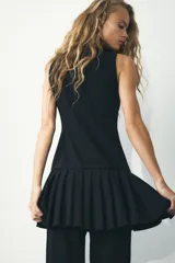 Vestido marrón sin mangas con cuello redondo y falda con pliegues.