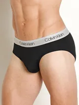 Pack de 3 slips Calvin Klein de corte clásico, confeccionados en tejido micro stretch de poliéster y elastano. Incluye tres slips negros con cinturas elásticas de diferentes colores: gris, dorado y blanco, con el logo de la marca.