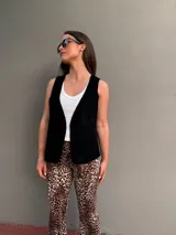 Chaleco negro de cuero con corte clásico y solapas.