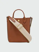 Bolso tote Longchamp modelo Épure XS, color marrón cuero, con correa larga de tela color crudo.