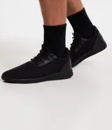 Championes negros de running, con capellada de tejido de punto, ajuste con cordones y suela texturizada.