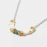 Collar con cadena plateada y dije con cuentas cilíndricas de color blanco, dorado, turquesa y cobre.