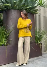 Sweater azul con diseño de flor en el frente y detalles de volados en puños y ruedo.