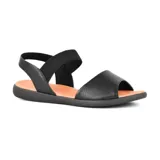 Sandalias bajas de cuero negro con elástico en el tobillo y plantilla color caramelo.