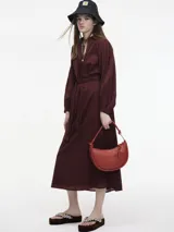 Vestido midi azul marino con botones en el escote y lazo ajustable en la cintura.
