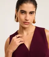Chaleco color borgoña con escote en pico y cierre sencillo. La prenda tiene una solapa delantera que da la apariencia de bolsillos.