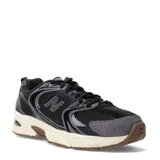 Championes New Balance 530 unisex, color negro con detalles en gris y blanco crema. Presentan una capellada de malla transpirable con refuerzos sintéticos y entresuela con tecnología ABZORB.