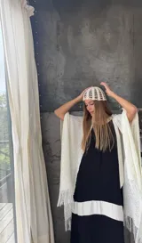 Ruana tejida a mano en color amarillo, de diseño liviano con flecos en el ruedo. Confeccionada en hilo, presenta un punto abierto y fluido.