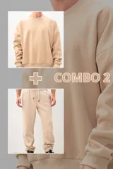 Conjunto deportivo beige compuesto por un buzo de cuello redondo y un pantalón jogging con cintura ajustable con cordón. El buzo es de corte holgado y el pantalón tiene puños ajustados.