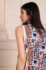 Vestido midi plisado con estampado de hojas en tonos marrones y ribete blanco en cuello y sisas.