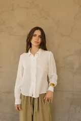 Camisa blanca de bambula de algodón con botones de nácar y corte holgado.