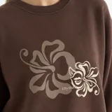 Buzo marrón de corte holgado con cuello redondo y puños acanalados. Estampado de flores en el frente.