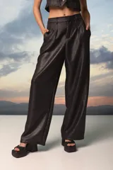 Pantalón de vestir tiro alto, corte sastrero con pinzas delanteras y pretina elastizada en la espalda. Confeccionado en crepe de sastrería con lurex, lo que le da un acabado brillante.