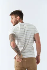 Remera de hombre a rayas horizontales blancas y beige, de manga corta, con bolsillo en el pecho y logo estampado.