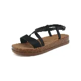 Sandalias negras con plataforma marrón, tiras cruzadas en el empeine y tira con hebilla al tobillo.