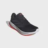 Championes de running Adidas Supernova Ease, color negro con detalles en violeta y suela blanca con detalles en rojo.