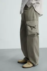 Pantalón cargo de algodón color verde oliva, corte regular fit, con bolsillos laterales con fuelle y solapa, y efecto lavado.