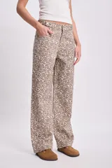 Pantalón de jean de corte recto con estampado animal print en tonos beige y marrón.