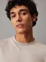 Remera color beige de algodón con logo de Calvin Klein bordado en el pecho.