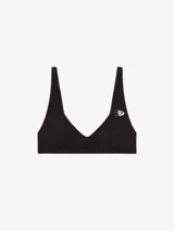 Sujetador tipo bralette de encaje con estampado camuflado en tonos marrones/beige. Tiene tirantes finos y un pequeño logo en el centro del busto.