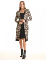 Vestido de tejido de punto marca Nina Leonard, con diseño Twofold que simula un conjunto de vestido negro liso y cárdigan largo con estampado geométrico blanco y negro. Presenta escote redondo y manga larga de corte recto.