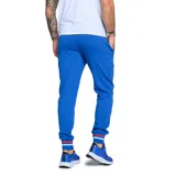 Pantalón de jogging azul marino con cintura elástica ajustable, bolsillos laterales con cierre y logo del Club Nacional de Football estampado en la pierna izquierda.